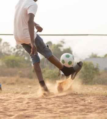 close-up-boy-running-after-ball